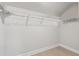 A walk-in closet with white wire shelving, base trim and light wood flooring at 3400 Palmer Lake Pointe, Douglasville, GA 30135