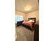 Cozy bedroom with neutral carpeting, a large window, and a comfortable queen-sized bed at 8325 Loch Lomand Ln, Winston, GA 30187
