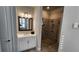 Well-lit bathroom showcasing a glass shower, white vanity, and contemporary fixtures at 188 Foxtail Rd, Woodstock, GA 30188
