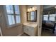 Bright bathroom featuring a white vanity, modern lighting, and view to the bedroom at 188 Foxtail Rd, Woodstock, GA 30188