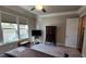 Neutral bedroom featuring a TV, dark wood furniture, soft carpet, and natural light at 188 Foxtail Rd, Woodstock, GA 30188
