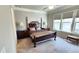 Well-lit bedroom with plush carpet, elegant furnishings, and bright, sunny windows at 188 Foxtail Rd, Woodstock, GA 30188