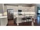 Modern kitchen features white cabinets, stainless steel appliances, and a large center island with seating at 188 Foxtail Rd, Woodstock, GA 30188
