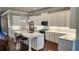 Modern kitchen with white cabinets, stainless steel appliances, quartz countertops, and hardwood floors at 188 Foxtail Rd, Woodstock, GA 30188