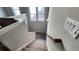 Carpeted staircase with wooden handrail leading down from the upper level of the house at 188 Foxtail Rd, Woodstock, GA 30188