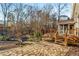 Beautiful backyard with a stone patio, wooden deck, landscaped garden, and a cozy fire pit area at 3672 Howell Wood Nw Trl, Duluth, GA 30096