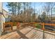 Large wooden deck with wooden and metal railing overlooking a wooded area in the backyard at 3672 Howell Wood Nw Trl, Duluth, GA 30096