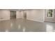 Unfinished basement with concrete floors, painted walls, and natural light from one window at 3672 Howell Wood Nw Trl, Duluth, GA 30096