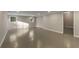 Unfinished basement with concrete floors, painted walls, and natural light from two windows at 3672 Howell Wood Nw Trl, Duluth, GA 30096