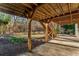 Basement view with concrete flooring and wooden support beams leading to the backyard and stone landscaping at 3672 Howell Wood Nw Trl, Duluth, GA 30096