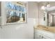Bathroom featuring a sink vanity with bright light fixtures and a large window at 3672 Howell Wood Nw Trl, Duluth, GA 30096