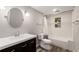 A bathroom with a dark vanity, white countertops, and a shower-tub with modern fixtures at 3672 Howell Wood Nw Trl, Duluth, GA 30096