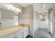 Bathroom with large mirror, double vanity, neutral wall paint and tile flooring at 3672 Howell Wood Nw Trl, Duluth, GA 30096