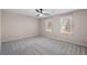 Neutral bedroom features carpeted floors, ceiling fan and windows for natural light at 3672 Howell Wood Nw Trl, Duluth, GA 30096