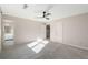 Bright bedroom features a ceiling fan, natural light, and carpeted floors and an ensuite bathroom at 3672 Howell Wood Nw Trl, Duluth, GA 30096
