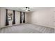 Spacious bedroom with three large windows allowing natural light and ceiling fan at 3672 Howell Wood Nw Trl, Duluth, GA 30096