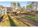 Home exterior with a screened porch, wooden deck, walkout basement, and landscaped backyard at 3672 Howell Wood Nw Trl, Duluth, GA 30096