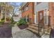 Home's front entrance with brick stairs, black railings, and a wooden front door at 3672 Howell Wood Nw Trl, Duluth, GA 30096