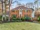 Traditional brick home with manicured front lawn, mature trees, and inviting entryway at 3672 Howell Wood Nw Trl, Duluth, GA 30096