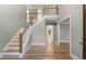 Inviting foyer with hardwood floors, staircase, and high ceilings at 3672 Howell Wood Nw Trl, Duluth, GA 30096