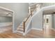 Spacious foyer with light hardwood floors, staircase, and views into other rooms at 3672 Howell Wood Nw Trl, Duluth, GA 30096