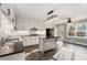 Updated kitchen with white cabinets, a center island, modern appliances, and seamless connection to the outdoors at 3672 Howell Wood Nw Trl, Duluth, GA 30096