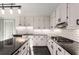 Bright kitchen features white cabinets, black countertops, stainless steel appliances, and subway tile backsplash at 3672 Howell Wood Nw Trl, Duluth, GA 30096