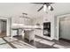 Updated kitchen with white cabinets, a center island, modern appliances, tile backsplash, and stylish lighting at 3672 Howell Wood Nw Trl, Duluth, GA 30096