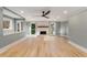 Spacious living room with hardwood flooring, large windows, a ceiling fan, and a fireplace at 3672 Howell Wood Nw Trl, Duluth, GA 30096