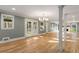 Bright living area with hardwood floors, large windows, a chandelier, and views of the outdoor surroundings at 3672 Howell Wood Nw Trl, Duluth, GA 30096