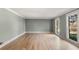 Bright and airy living room with hardwood floors, large windows, and neutral paint at 3672 Howell Wood Nw Trl, Duluth, GA 30096