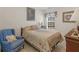 Cozy bedroom with a bed, chair, window with blinds, and decorative lamps at 507 Mockingbird Ln, Loganville, GA 30052
