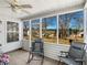 Enjoy relaxing in this enclosed back porch with fan and nice view at 507 Mockingbird Ln, Loganville, GA 30052