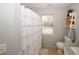 Cozy bathroom with tiled floors, granite countertops and patterned shower curtain at 70 Oaklake Dr, Covington, GA 30016