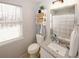 Cozy bathroom with tiled floors, granite countertops and patterned shower curtain at 70 Oaklake Dr, Covington, GA 30016