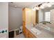 Bathroom with a granite countertop, white sink, and cherry wood cabinets at 70 Oaklake Dr, Covington, GA 30016