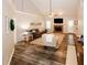 Bright living room with vaulted ceilings, a brick fireplace, and wood-look flooring at 70 Oaklake Dr, Covington, GA 30016