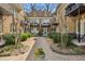 Beautifully landscaped courtyard with flowerbeds, green bushes, brick walkway, and inviting entrances at 907 Piedmont Ne Ave # 7, Atlanta, GA 30309