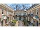 Charming courtyard-style building with brick facade, balconies, and well-manicured landscaping at 907 Piedmont Ne Ave # 7, Atlanta, GA 30309