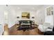 Bright living room with hardwood floors, stylish furnishings, and natural light streaming through a window at 907 Piedmont Ne Ave # 7, Atlanta, GA 30309