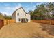 Spacious fenced backyard featuring a patio seating area with a pergola and ample space for recreation at 125 Sunland Blvd, Mcdonough, GA 30253