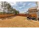 Large, grassy backyard with a privacy fence, pergola, and outdoor seating area at 125 Sunland Blvd, Mcdonough, GA 30253