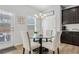 Cozy dining area with modern lighting, a glass table and an open view of the backyard at 125 Sunland Blvd, Mcdonough, GA 30253