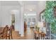 Inviting home foyer with wood-look floors, featuring a console table, modern mirror, and dining area at 125 Sunland Blvd, Mcdonough, GA 30253