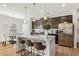 Open-concept kitchen with a large island, pendant lighting, stainless steel appliances, and adjacent dining area at 125 Sunland Blvd, Mcdonough, GA 30253