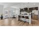 Modern kitchen with stainless steel appliances, a large island, and pendant lighting with an adjacent dining area at 125 Sunland Blvd, Mcdonough, GA 30253