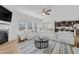 Bright living room with a fireplace and large white sectional sofa with views into the kitchen and dining area at 125 Sunland Blvd, Mcdonough, GA 30253