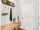 Cozy mud room entry area features a wooden bench, decorative hooks and a 