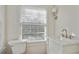 Bathroom features a marble-top vanity with white cabinets and modern fixtures at 1989 Mount Vernon Rd, Atlanta, GA 30338