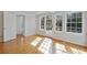 Sun-lit bedroom featuring hardwood floors, with white trim, and french doors to the outside deck at 1989 Mount Vernon Rd, Atlanta, GA 30338